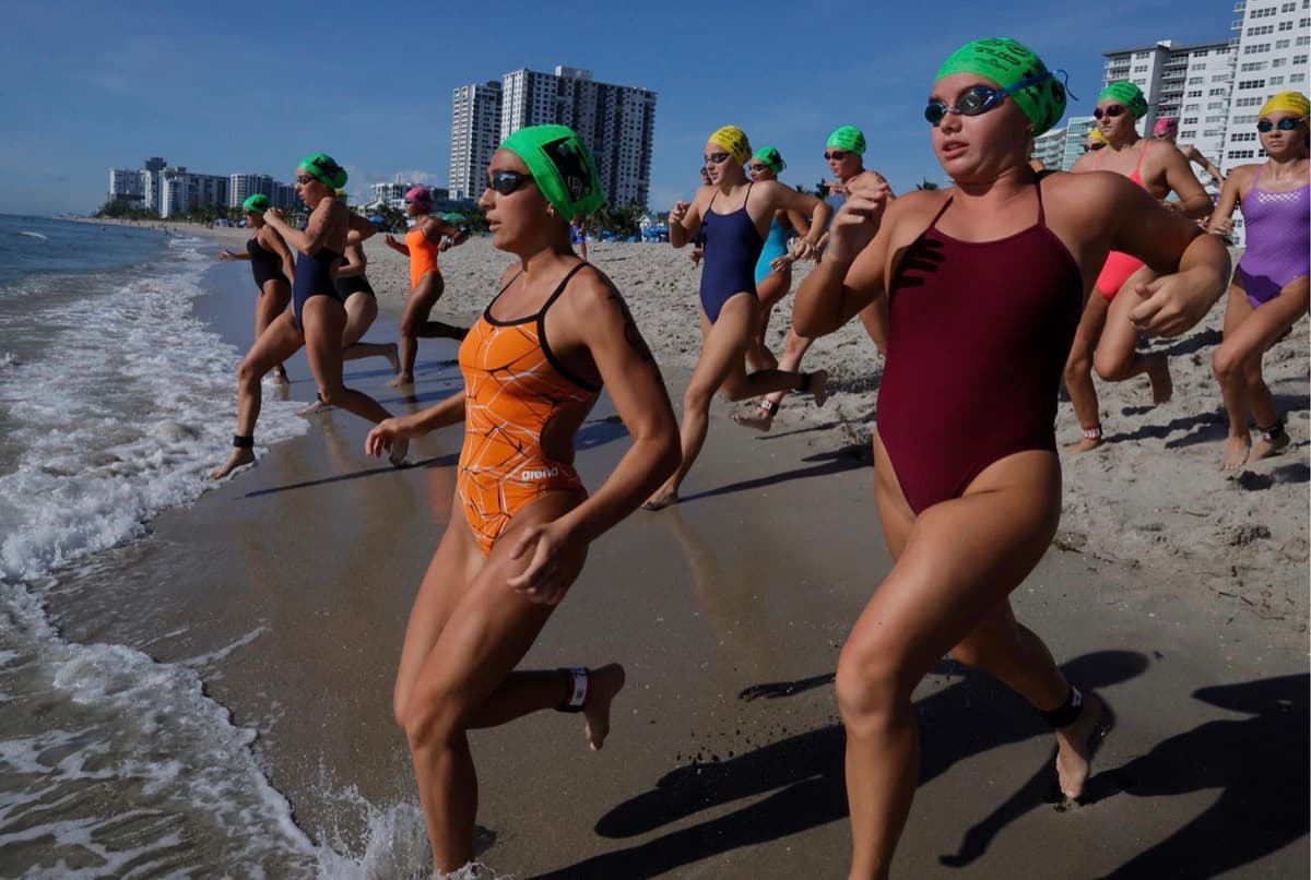 Women charging into the ocean